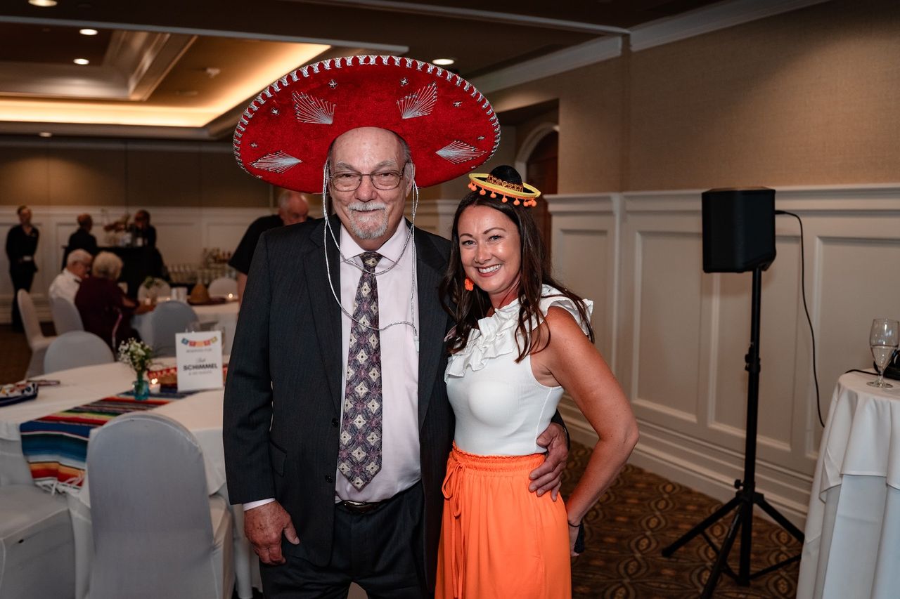 A guest in a sombrero with a friend