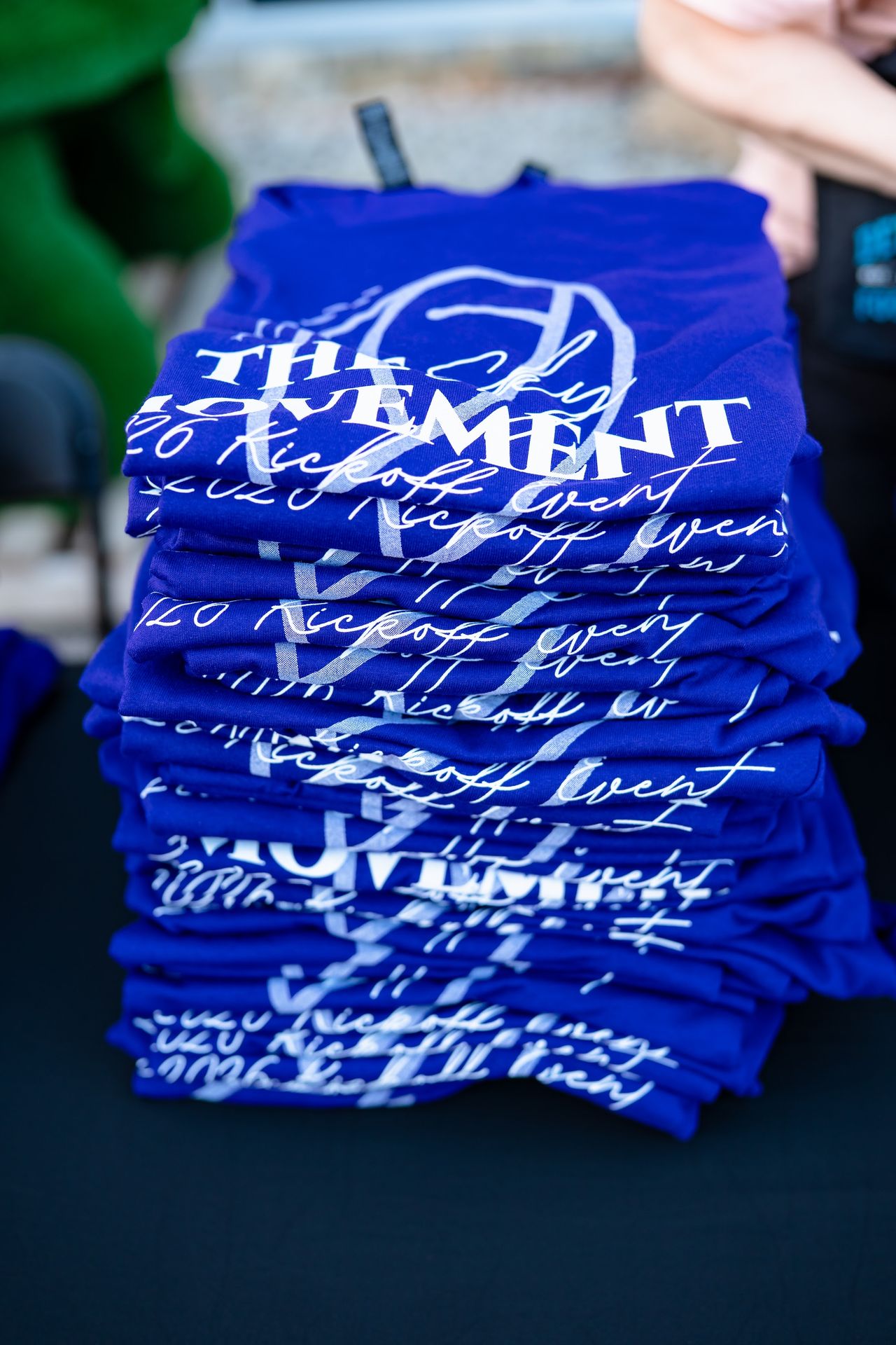 A stack of purple Sky Movement shirts