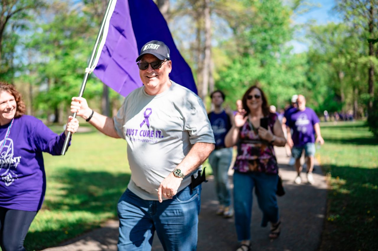 A flag bearer leading walkers through the park